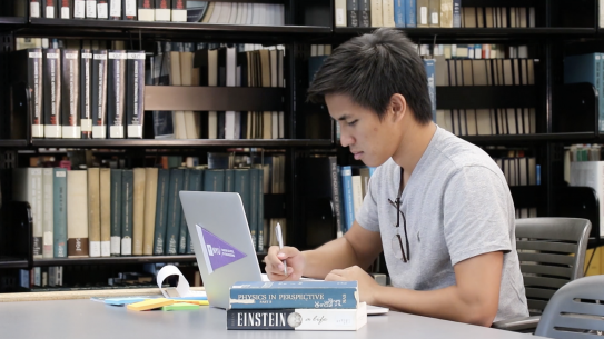 student in library