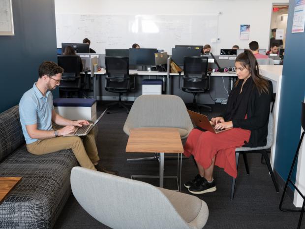 man and a woman working in lounge area of Future Labs