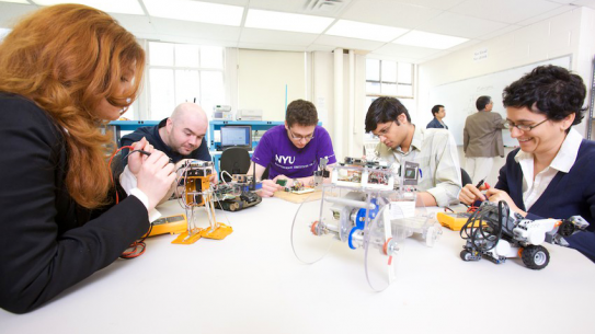 teachers working on robots